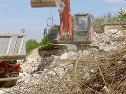 MS excavator loading material in dumper at deconstruction of bridge over river Mosel / Wellen, Rhineland Palatinate, Germany Stock Footage