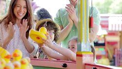 Children winning prize at amusement park Stock Footage