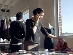 MS Fashion designer working while talking on phone and assistants in background / New York City, New York, USA Stock Footage
