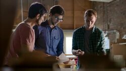 Creative young people compare handwritten notes on paper to information on tablet computer Stock Footage