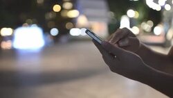 HD:Woman touching smartphone at night time Stock Footage