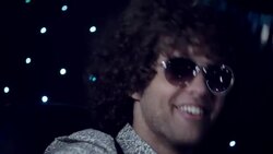 Rockstar in limousine jams on acoustic guitar for fans and paparazzi at awards show Stock Footage