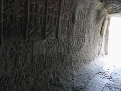 Geghard monastery, tourists walking out from a church Stock Footage