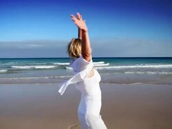 Woman spinning on beach Stock Footage