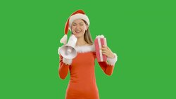 young charming girl dabbles with megaphone and a gift Stock Footage