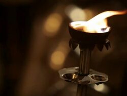 CU Bronze torch burning at night / Varanasi, India Stock Footage