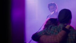 Young adult couple gets photo taken on cellphone at concert Medium shot dolly Stock Footage