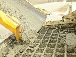 Cement Mixer Truck Trough Unloading Concrete at Construction Site Stock Footage