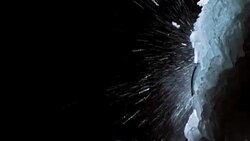 Ice climber ascending the steep frozen waterfall Stock Footage