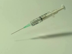 High speed Syringe falls on to surface, white background Stock Footage