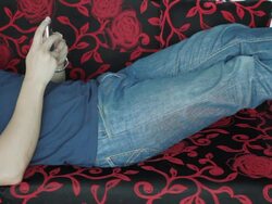 Asian male relax on sofa with smartphone Stock Footage