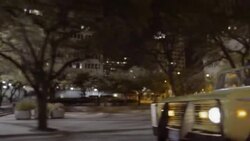 Friends in classic Ford Bronco speed through downtown Austin, Texas at night Stock Footage