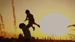 SLO MO Father lifting his son up in the air Stock Footage
