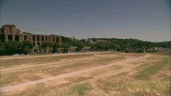 Traffic travels between Rome's ancient ruins and the Circus Maximus. Stock Footage