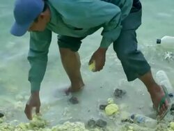 MS TU Miner working with his feet inside the Ijen lake that has very acid water / Ijen, Java, Indonesia Stock Footage