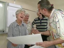 HD: Lecturer Examining Paintings With Senior Students Stock Footage