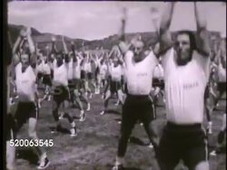 1963: UNITED STATES AIR FORCE ACADEMY: VS Training instructor shouting instructions, cadets on field performing squats & jumping jacks, upper classmen supervising. Physical training, PT, Colorado, CO, Rampart Range Instructional Video