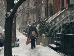 WS Man walking up her stairs during snow / New York City, New York, USA Stock Footage