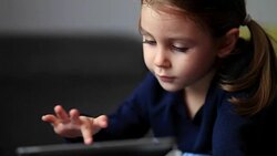 Little cute girl using tablet PC Stock Footage