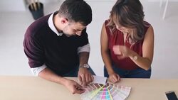 Interior designers pointing at colour charts Stock Footage