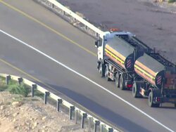 AERIAL WS TS View of moving truck on road in Desert / Sourn Judea Desert, Israel Stock Footage