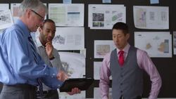 MS Mature businessman using digital tablet to present project ideas to coworkers in office conference room Stock Footage