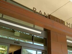 WS PAN from sign Rancho Mirage Public Library to mirrored glass entry area reflecting the outdoors / Rancho Mirage, California, USA Stock Footage