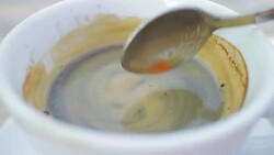 Close-up: Cup of fresh coffee on a cafe table outdoors Stock Footage