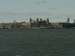 Long Shot static - Buildings of Ellis Island cluster together on the shore across Upper New York Bay. / Ellis Island, New York, USA Stock Footage