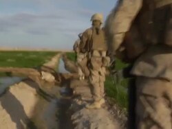 WS ZI Group of soldiers walking on field / Mausa Qala, Helmand Province, Afghanistan. Stock Footage
