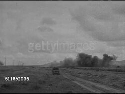 1942: PACIFIC FRONT: WS TRACKING Unidentified aircraft in flight, smoke from wing area. WS Explosion in open field. VS US Soldiers, Marines, sailors firing anti-aircraft guns, cannons, artillery on ships, loading ammunition. Pacific Theater, WWII. Instructional Video