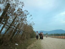 WS Woman walking on dirt road /  Vang Vieng, Vientiane, Laos Stock Footage