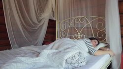 Woman in bed woken up by the alarm on the mobile phone. Stock Footage