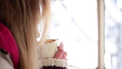 Woman having a tea or coffee on snowy day. Stock Footage