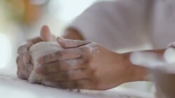 Pastry chef rolls and shapes dough in flour Stock Footage
