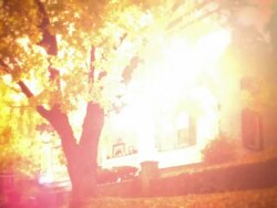 REENACTMENT ORANGE wide shot tilt up from fallen leaves + 1920s car (Model T?) to house + tree in Autumn / intense FLARE Stock Footage