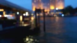 Bokeh of cityscape along river Stock Footage