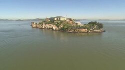 The waters of San Francisco Bay surround Alcatraz Island and prison. Stock Footage