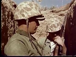 1950s MONTAGE Soldiers waiting in trenches / MS Two soldiers standing nervously / HA  Two men in trench / CU  resting helmet against rifle at Camp Desert Rock at Nevada Test Site / Nye County, Nevada, USA Stock Footage