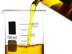 Pouring yellow liquid into Beaker Stock Footage