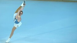 SLO MO TS Female figure skater holding figure while gliding Stock Footage