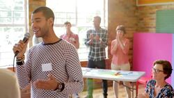Audience clapping for speaker with microphone Stock Footage