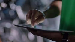 Shop worker checks bicycle price tag and scrolls through inventory on tablet Stock Footage