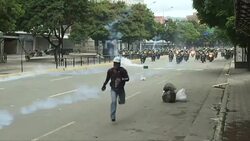 CLEAN : Police on motorbikes chase down protesters in Caracas News Clip