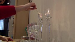 Woman Lighting Candles Ahead of Sabbath News Clip