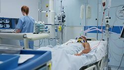 DS Nurse checking young male patient in intensive care Stock Footage