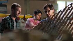 Wood shop owner shows off custom chair design to new employee Stock Footage