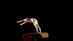 SLO MO Female gymnast doing back handspring on vault Stock Footage