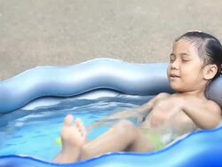 asia girl  playing in a paddling pool Stock Footage