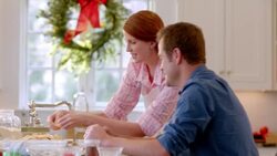 Man and woman fixing pie chat and laugh in the kitchen (dolly-shot) Stock Footage